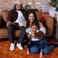 Taylor Burris Spikes with her husband and daughter.