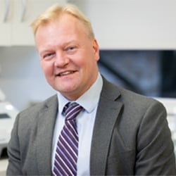 Headshot of Tomi Pastinen smiling.
