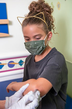 A Children's Mercy patient having a joint aspiration of her elbow.