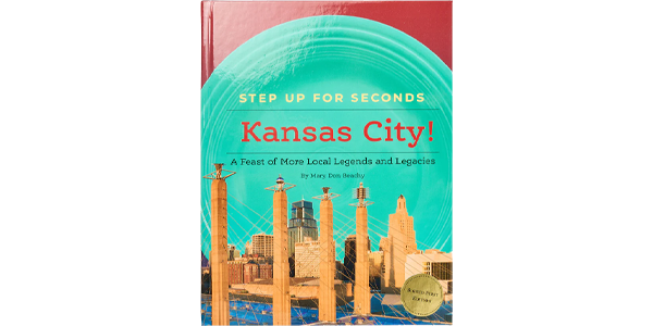 Cover of the book &ldquo;Step Up for Seconds: Kansas City!&rdquo; showing an illustrated Kansas City skyline with a teal circular design.