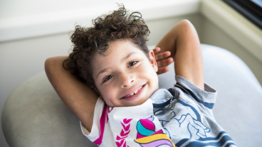 Kieesha Pentlin laying down with her arms behind her head and smiling.