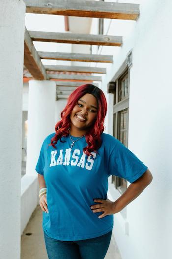 Lanayah wearing blue Kansas Shirt showing she is going to KU for college 
