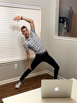 CHLN instructor stretching in front of a laptop.