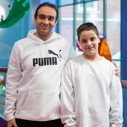 Mohamed is smiling with his dad at Children's Mercy.