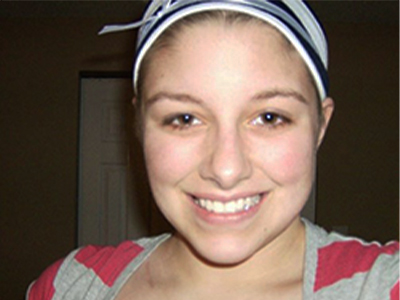 Close-up of a younger Shauna Beckett smiling.