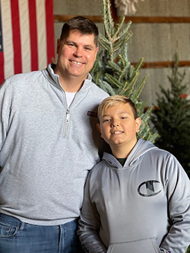 Hayden Murnahan and his father, Steve, smiling.