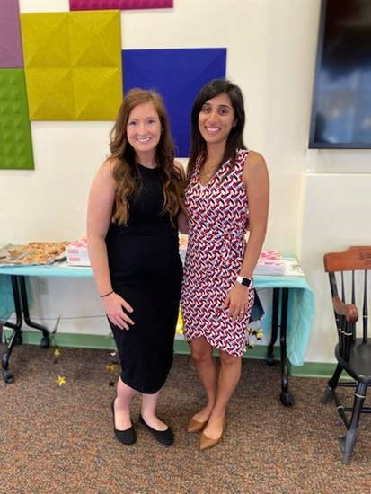 Two women stand together at the Pediatric Hematology Oncology Fellowship graduation.