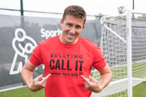 Sporting KC player pointing to his shirt that reads "Bullying. Call it when you see it."