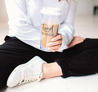 Woman holding a coffee mug tumbler