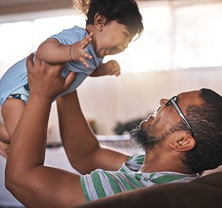 Dad holding up a baby