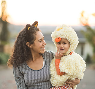 Mom holding child in chicken costume