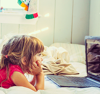 sisters watching tv on laptop