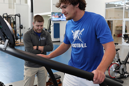 Michael Shultz on treadmill while physical therapist watches in background