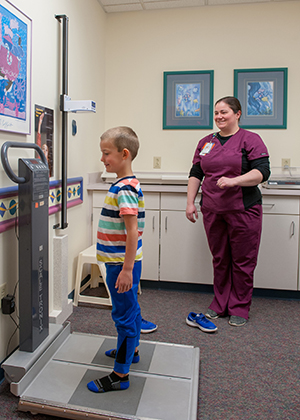 The nurse weighs a child in the Kidney Center at Children's Mercy.