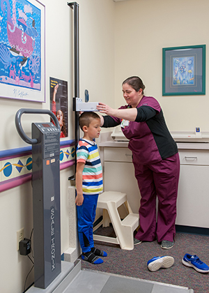 A nurse checks a child's height in the Kidney Center at Children's Mercy.